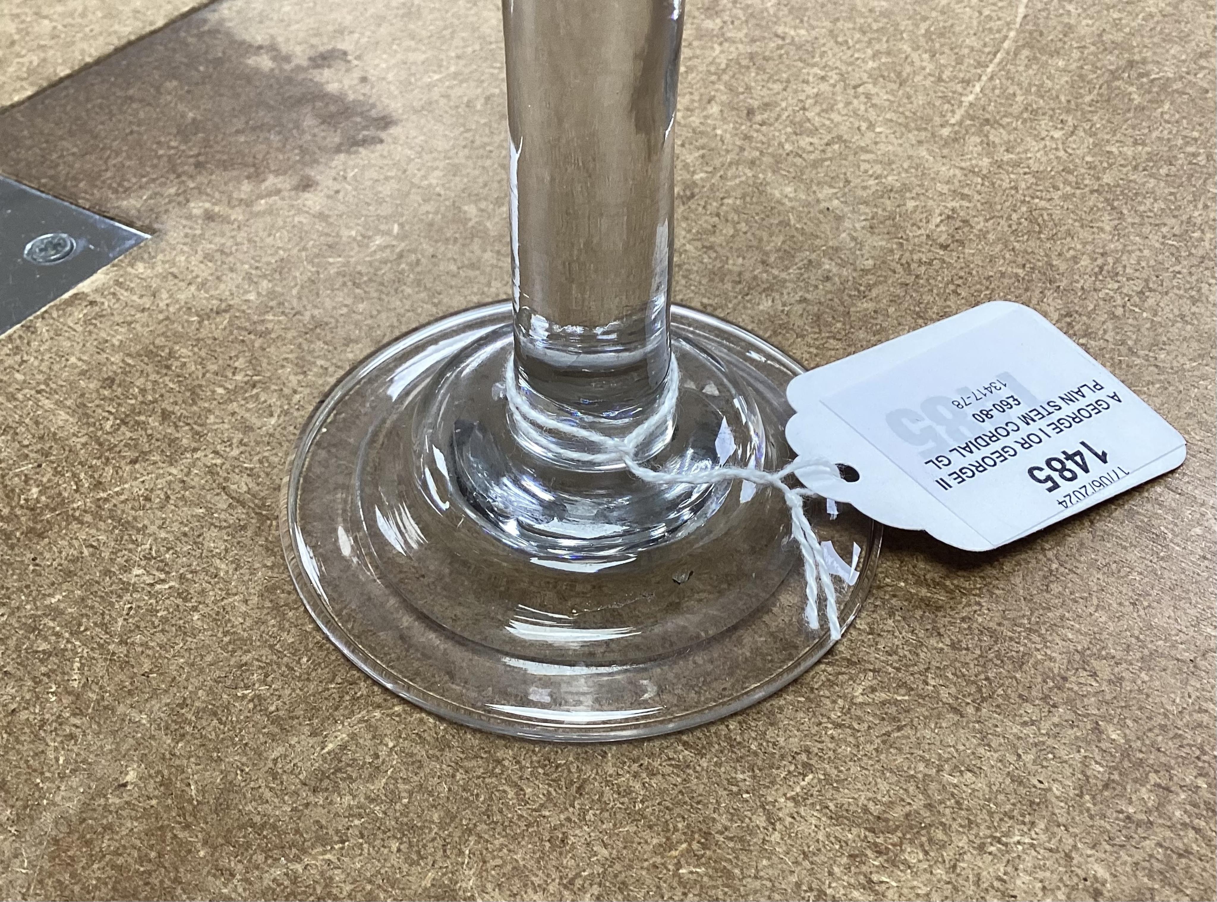 A George I or George II plain stem cordial glass, c.1720-30, with folded and domed foot and wheel engraved rim decorated with grape vines, 17.5cm